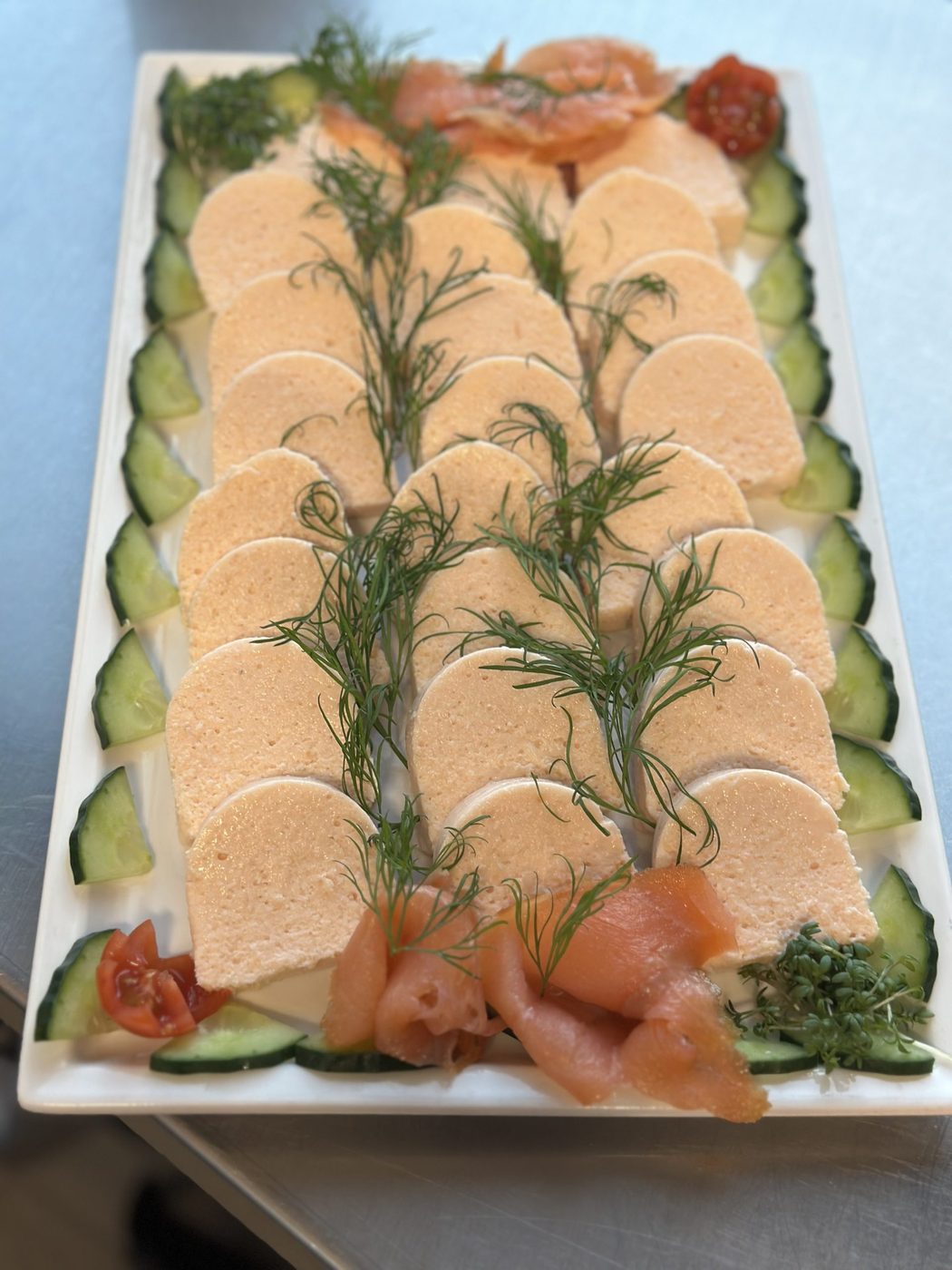 Platte mit Lachsröllchen, Dille und Gurke